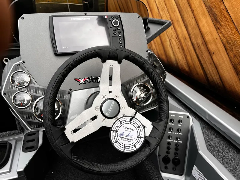 Slide: The Image of 2024 Vexus AVX1880 boat dashboard with steering wheel and control panel. - 12