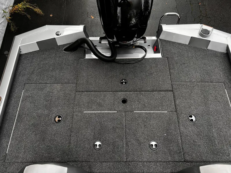 Slide: The Image of 2024 Vexus AVX1880 boat deck with carpeted surface and motor, viewed from above. - 8