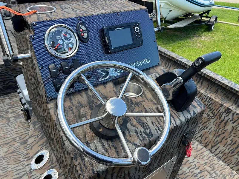 Slide: The Image of Steering console of 2022 Xpress H190B boat with gauges and controls. - 10