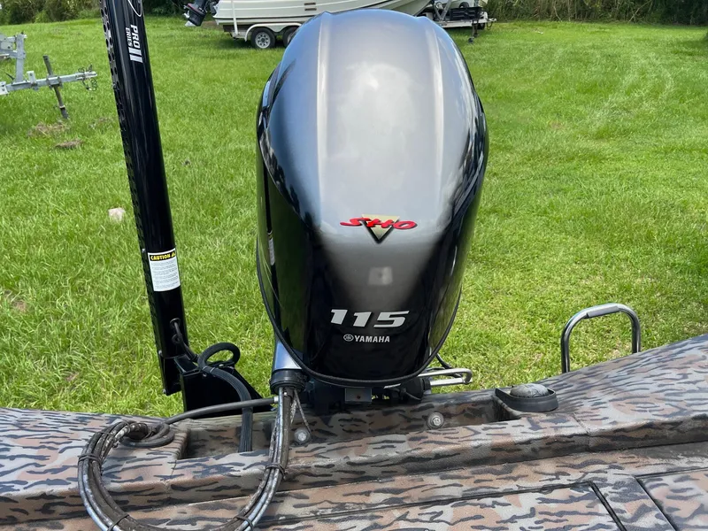 Slide: The Image of Yamaha 115 outboard motor on Xpress H190B boat, 2022 model, in grassy area. - 11
