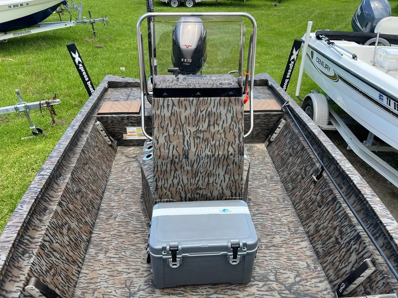 Slide: The Image of 2022 Xpress H190B boat interior with camouflage design and outboard motor. - 13