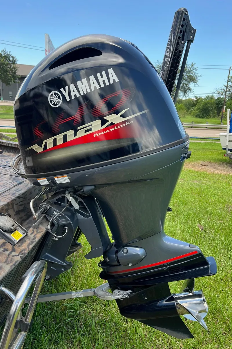 Slide: The Image of Yamaha VMAX outboard motor on 2022 Xpress H190B boat, parked on grass. - 16