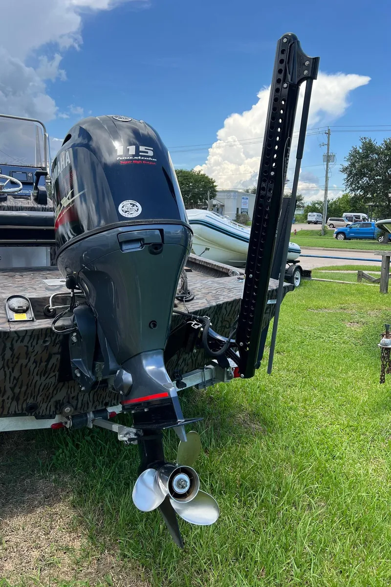 Slide: The Image of 2022 Xpress H190B boat with Yamaha 115 outboard motor on grassy area. - 17