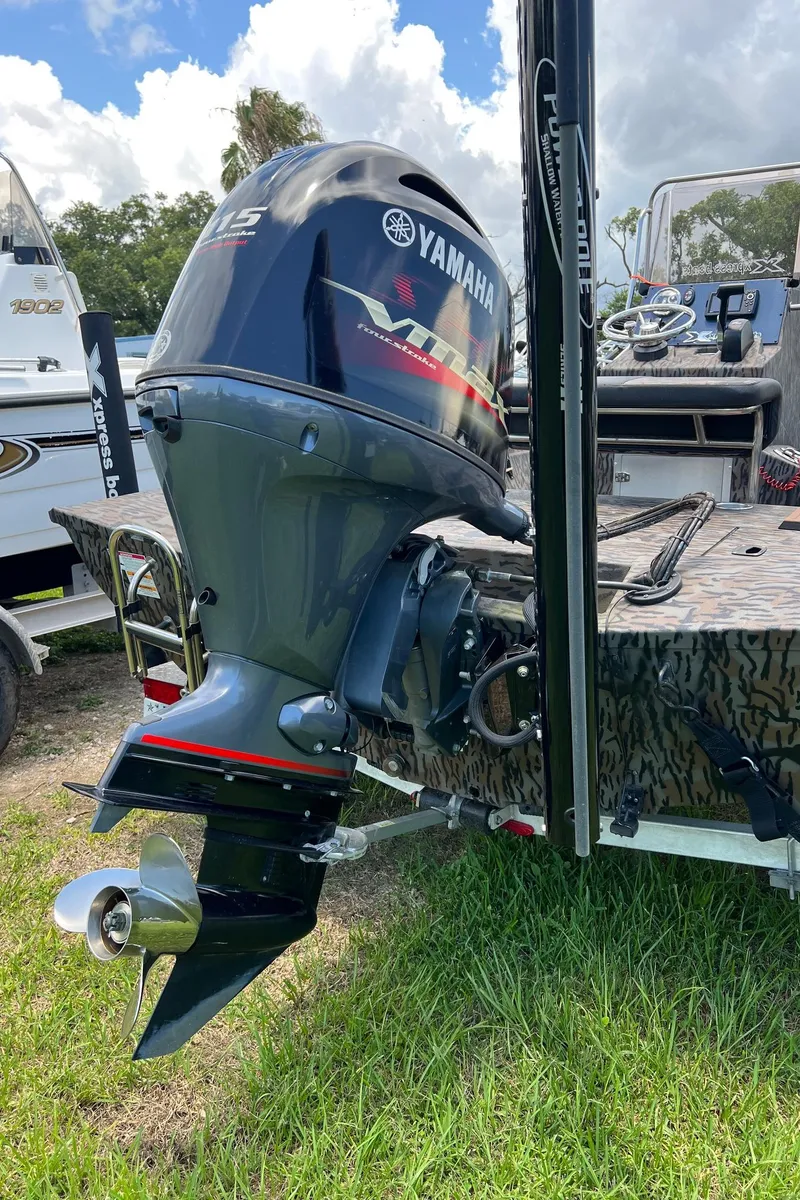 Slide: The Image of Xpress H190B 2022 boat with Yamaha outboard motor on grassy area. - 18