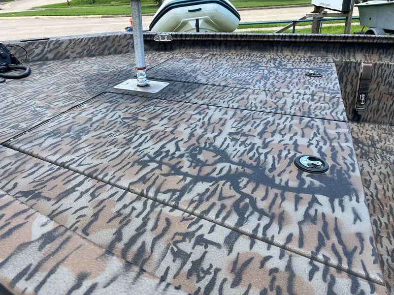 Slide: The Image of 2022 Xpress H190B boat deck with camouflage pattern and storage compartments. - 3
