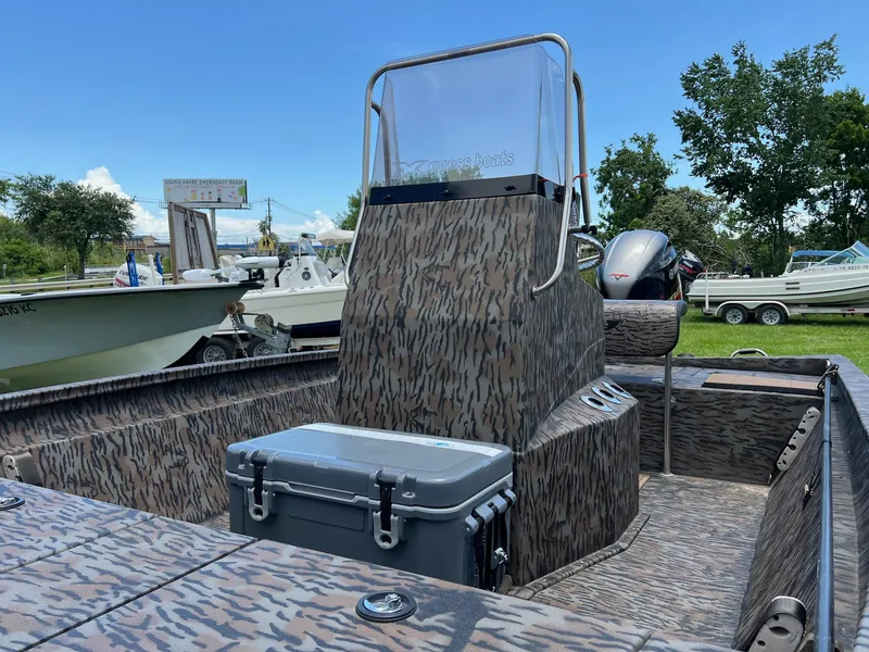 Slide: The Image of 2022 Xpress H190B boat with camouflage design and console, parked outdoors. - 4