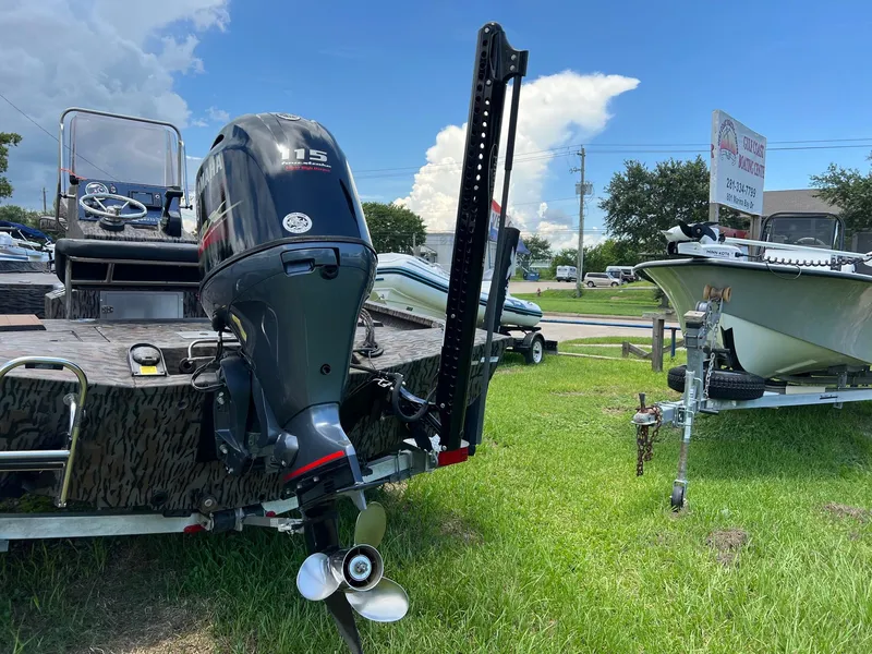 Slide: The Image of 2022 Xpress H190B boat with Yamaha 115 outboard motor on grassy lot. - 6