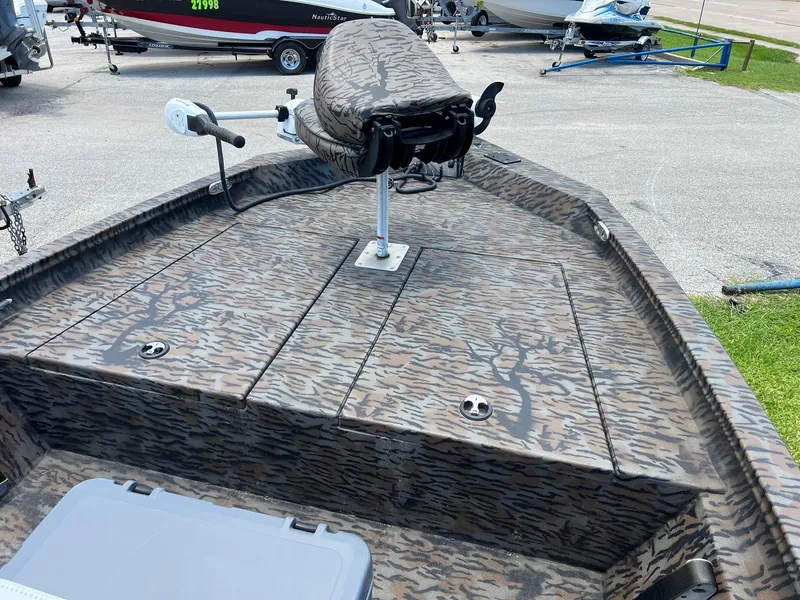 Slide: The Image of Camouflage-patterned 2022 Xpress H190B boat deck with mounted seat and trolling motor. - 8