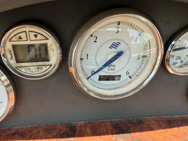 Slide: The Image of Dashboard gauges of a 2005 Four Winns 190 Horizon boat, showing RPM and digital display. - 4