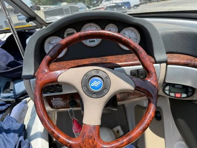 Slide: The Image of 2005 Four Winns 190 Horizon dashboard with wood-grain steering wheel and instrument panel. - 5