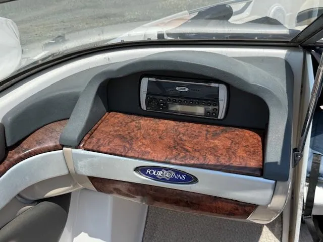 Slide: The Image of 2005 Four Winns 190 Horizon dashboard with wood paneling and stereo system. - 8