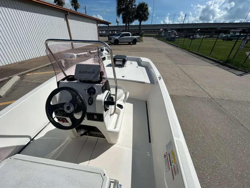 Slide: The Image of 2020 Mako Pro Skiff 17 CC boat with Garmin navigation, parked outdoors. - 11