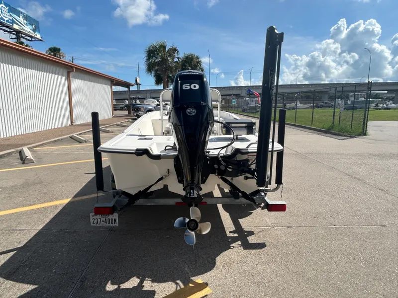 Slide: The Image of 2020 Mako Pro Skiff 17 CC boat with outboard motor in parking lot. - 6