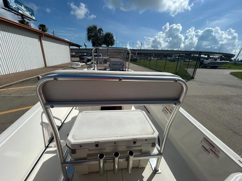 Slide: The Image of 2020 Mako Pro Skiff 17 CC boat interior with cooler and rod holders. - 8