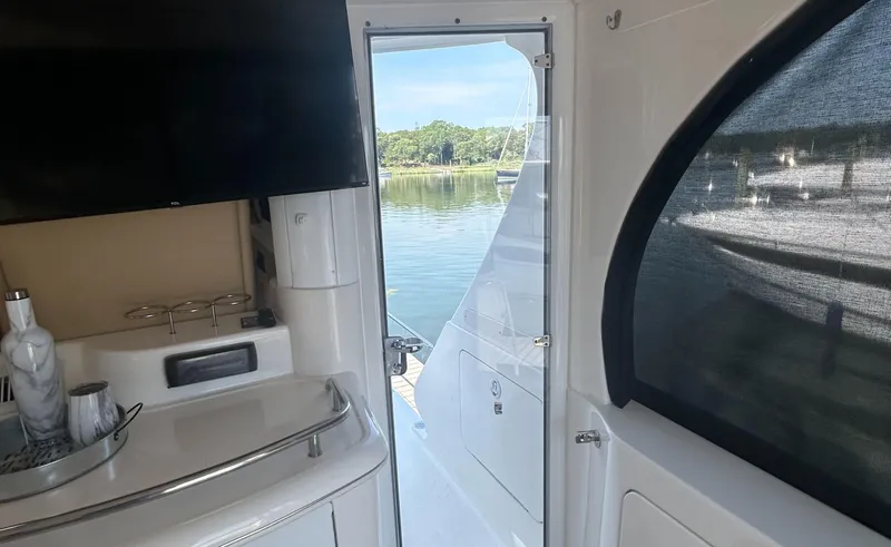 Slide: The Image of Interior view of 2002 Sea Ray 480 Motor Yacht with open door to scenic water. - 10