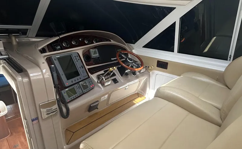 Slide: The Image of 2002 Sea Ray 480 Motor Yacht helm with navigation equipment and leather seating. - 13
