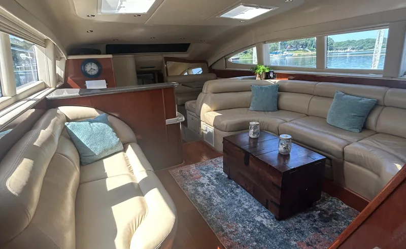 Slide: The Image of Luxurious interior of 2002 Sea Ray 480 Motor Yacht with leather seating and wooden accents. - 14