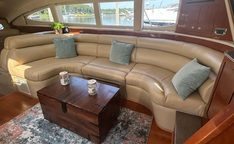 Slide: The Image of Luxurious 2002 Sea Ray 480 Motor Yacht interior with leather seating and wooden accents. - 15
