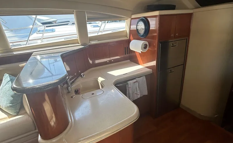 Slide: The Image of Luxurious kitchen area in a 2002 Sea Ray 480 Motor Yacht with modern amenities. - 16