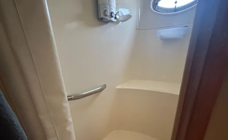 Slide: The Image of Shower area in 2002 Sea Ray 480 Motor Yacht with porthole and grab bar. - 20