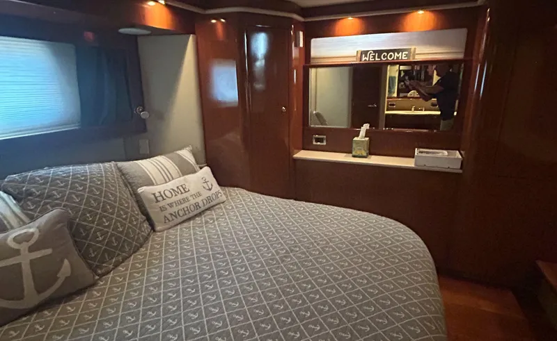Slide: The Image of Cozy bedroom in 2002 Sea Ray 480 Motor Yacht with nautical decor and warm lighting. - 23
