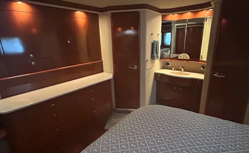 Slide: The Image of Luxurious interior of 2002 Sea Ray 480 Motor Yacht with wood cabinetry and elegant design. - 24