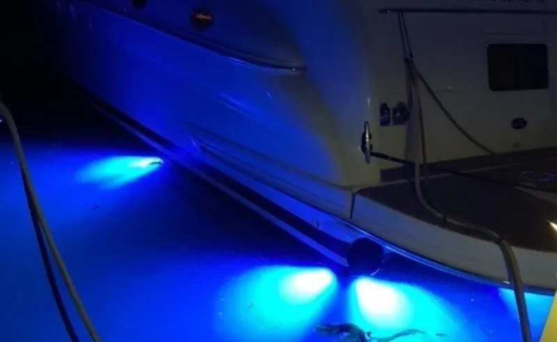 Slide: The Image of 2002 Sea Ray 480 Motor Yacht with vibrant blue underwater lights at night. - 30