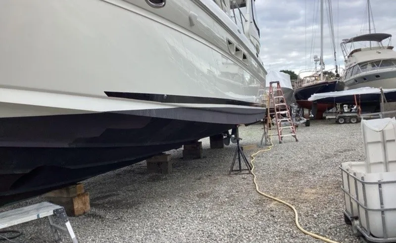 Slide: The Image of 2002 Sea Ray 480 Motor Yacht on dry dock with maintenance equipment nearby. - 35