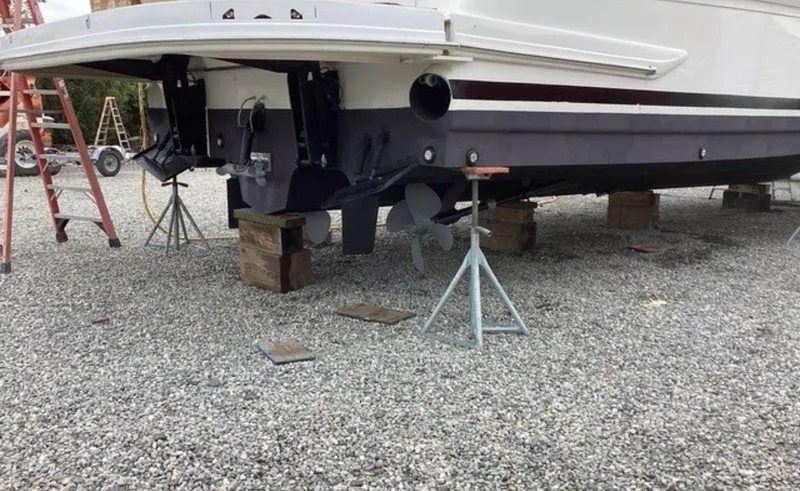 Slide: The Image of 2002 Sea Ray 480 Motor Yacht on blocks, showing propellers and hull. - 36