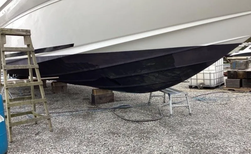 Slide: The Image of 2002 Sea Ray 480 Motor Yacht on dry dock with maintenance equipment nearby. - 37