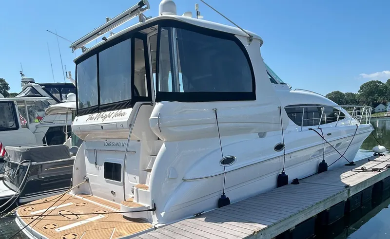 Slide: The Image of 2002 Sea Ray 480 Motor Yacht docked, featuring sleek design and spacious deck. - 4
