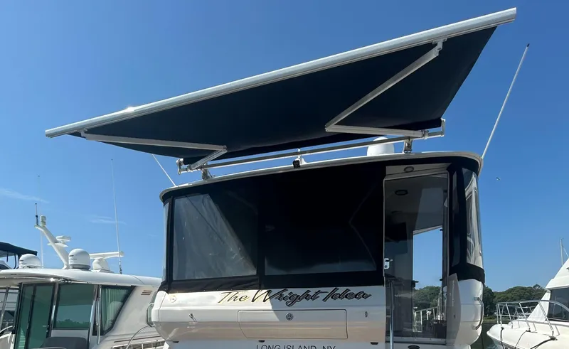 Slide: The Image of 2002 Sea Ray 480 Motor Yacht with extended canopy, docked at marina. - 6