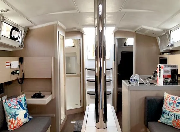 Slide: The Image of Interior of 2022 Beneteau Oceanis 38.1 yacht, featuring modern design and cozy seating area. - 11