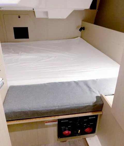 Slide: The Image of Cabin interior of 2022 Beneteau Oceanis 38.1 with bed and control panel. - 16