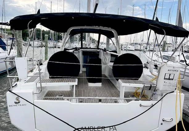 Slide: The Image of 2022 Beneteau Oceanis 38.1 sailboat docked at marina, rear view. - 2