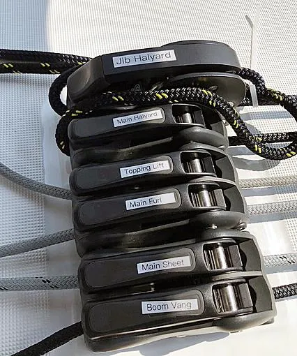 Slide: The Image of Sailing rope clutches on a 2022 Beneteau Oceanis 38.1, labeled for various sail controls. - 20