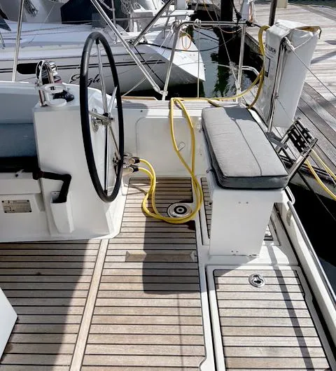 Slide: The Image of Beneteau Oceanis 38.1 cockpit, 2022 model, featuring a steering wheel and cushioned seating. - 9