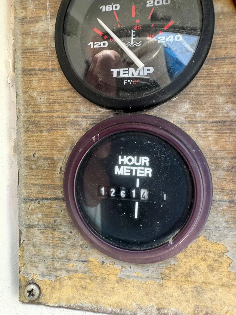 Slide: The Image of Hour meter and temperature gauge on 1984 Newport Sailboat dashboard. - 23