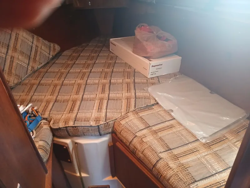 Slide: The Image of Cozy cabin interior of 1984 Newport Sailboat with plaid cushions and marine equipment. - 7