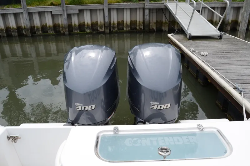 Slide: The Image of Twin Yamaha 300 engines on a 2017 Contender 28 Sport boat at dock. - 10