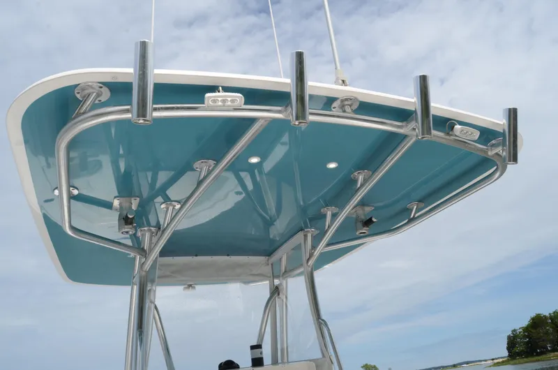 Slide: The Image of 2017 Contender 28 Sport boat's T-top with stainless steel frame against a cloudy sky. - 12