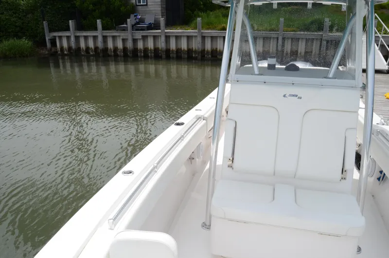 Slide: The Image of 2017 Contender 28 Sport boat docked by a wooden pier. - 15