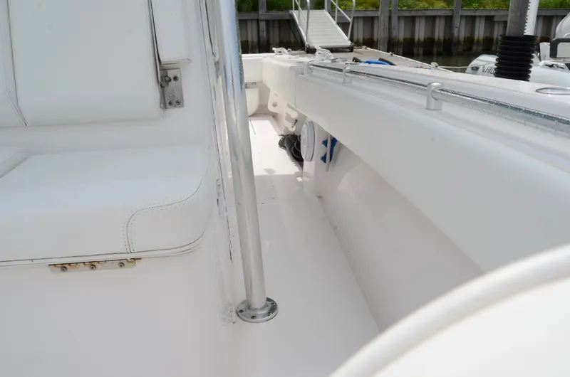Slide: The Image of 2017 Contender 28 Sport boat interior with white seating and railing. - 16