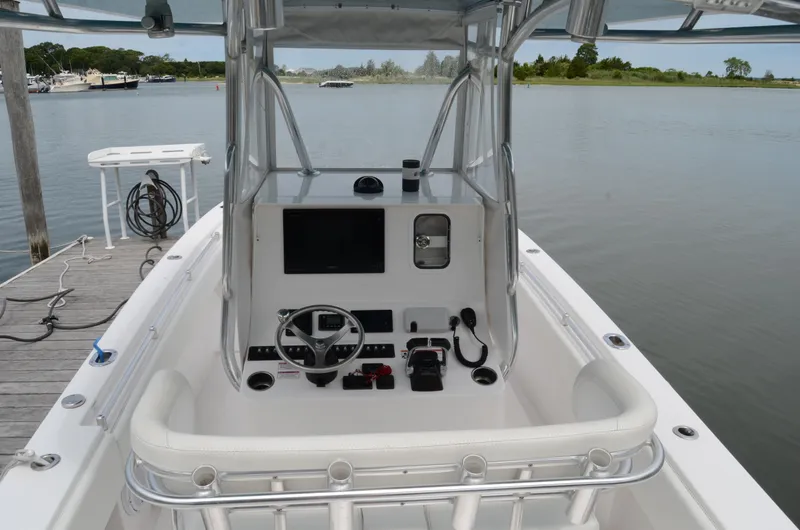 Slide: The Image of 2017 Contender 28 Sport boat at dock, featuring sleek helm and modern controls. - 23