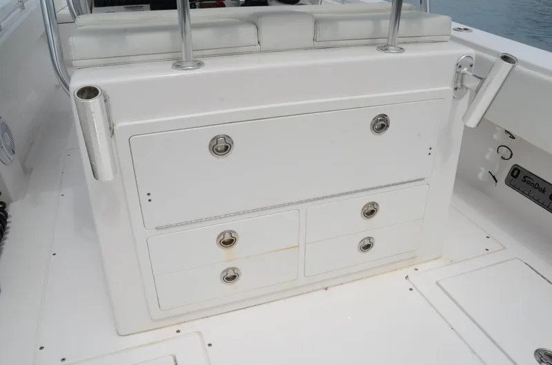 Slide: The Image of 2017 Contender 28 Sport boat storage compartments with rod holders and seating. - 24