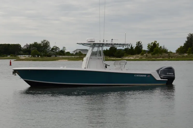 Slide: The Image of 2017 Contender 28 Sport boat on calm water, side view, with Yamaha outboard motor. - 3