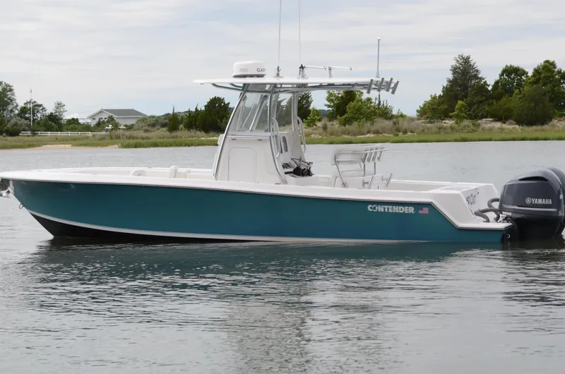 Slide: The Image of 2017 Contender 28 Sport boat with Yamaha engine on calm water. - 4