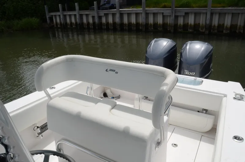 Slide: The Image of 2017 Contender 28 Sport boat with dual 300 horsepower engines, docked by a wooden pier. - 8