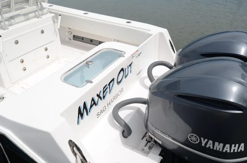 Slide: The Image of 2017 Contender 28 Sport boat with Yamaha engines, named "Maxed Out," docked at Sag Harbor. - 9