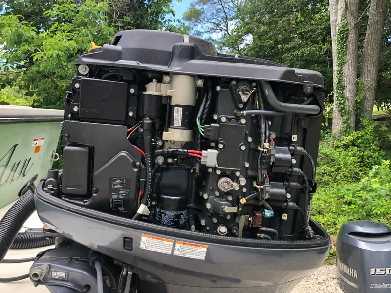 Slide: The Image of Open Yamaha outboard motor on a 2015 Parker 2530 Extended Cabin boat. - 13